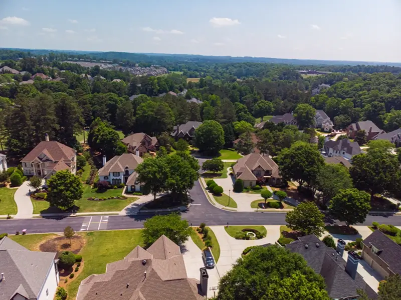 Aerial view of a suburban neighborhood with houses and trees.